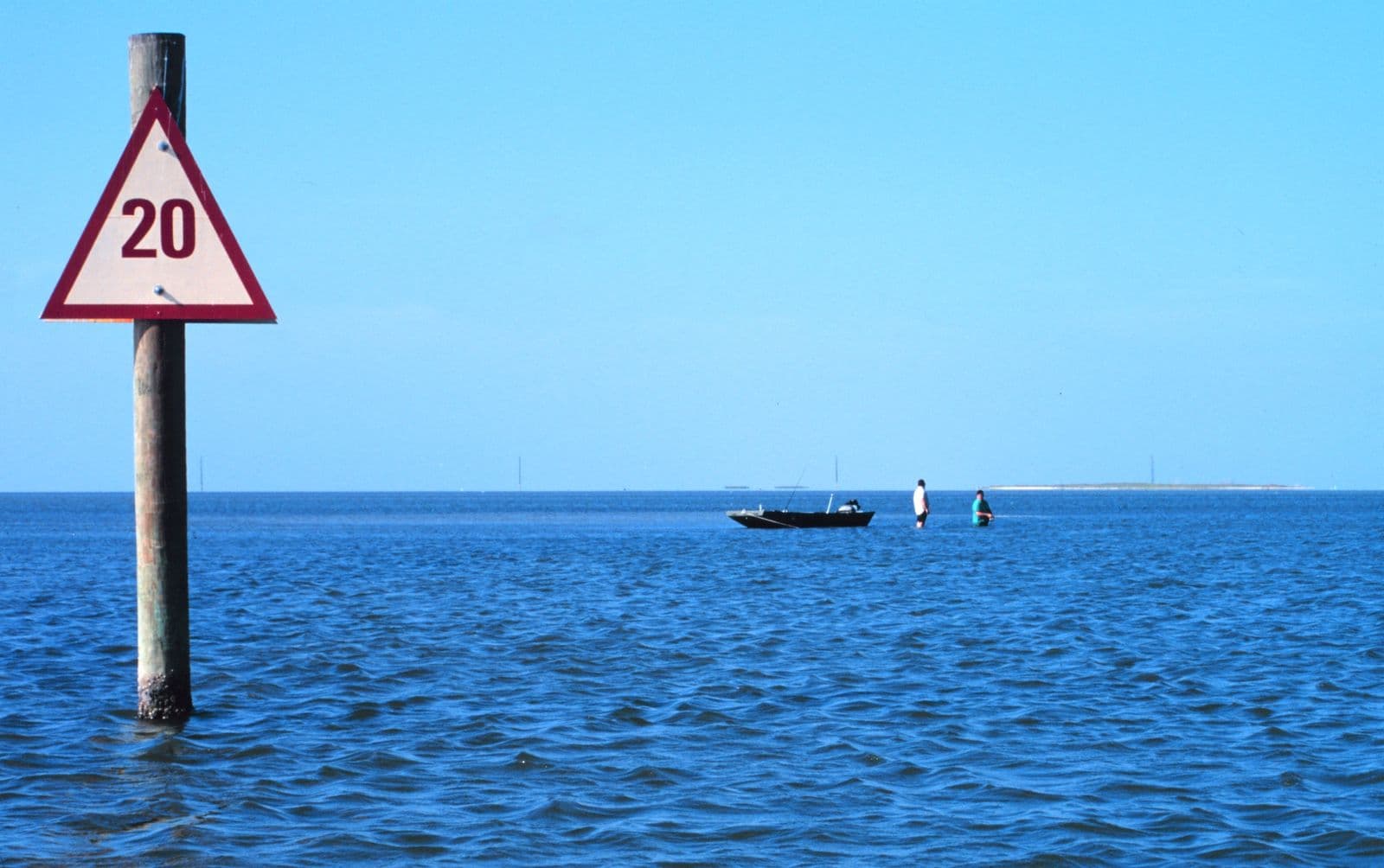 Calm Laguna Madre waters with a small fishing boat off Padre Island National Seashore