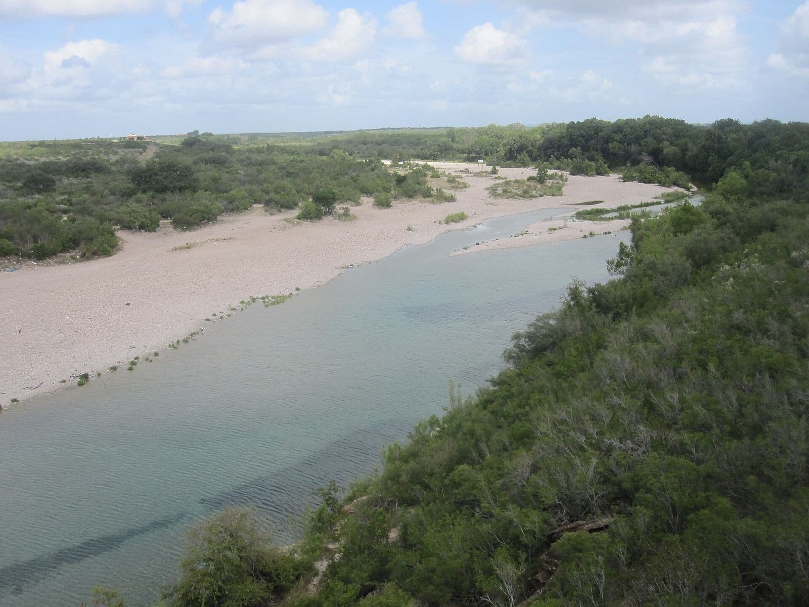 The Nueces River winding through green Texas country