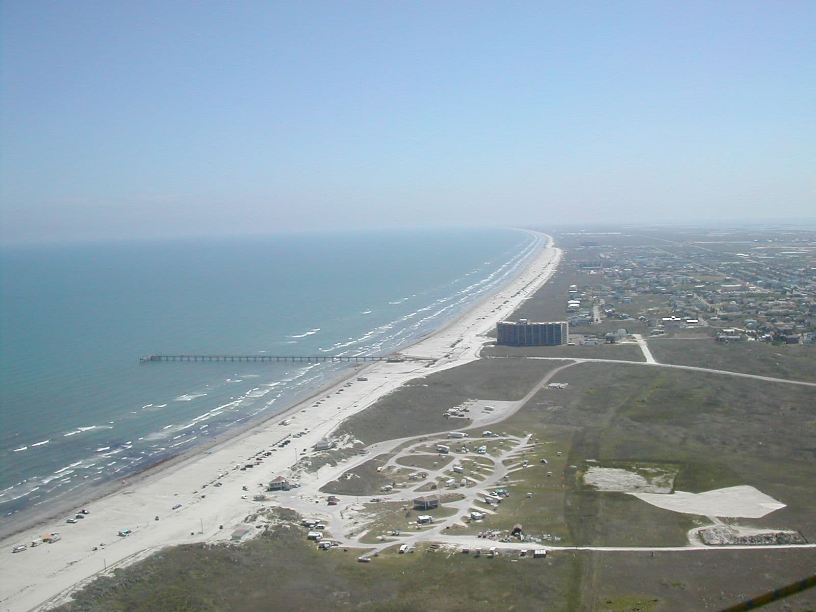 Aerial view of the wide beach and town of Port Aransas on Mustang Island