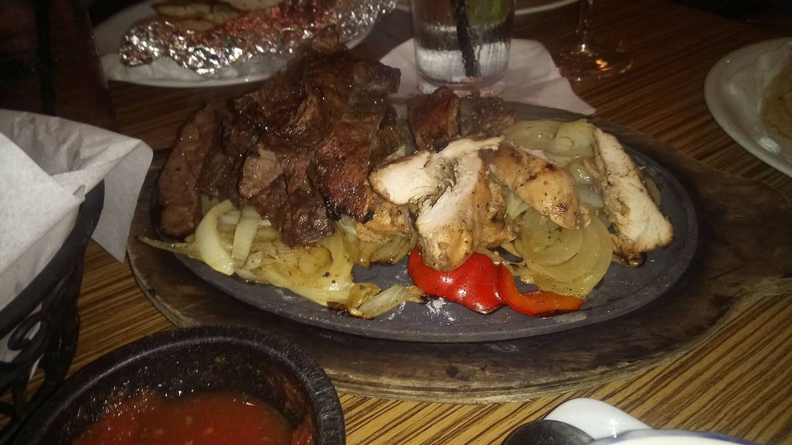 A sizzling platter of Tex-Mex fajitas with chips and salsa